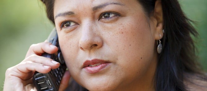 woman having serious conversation on phone