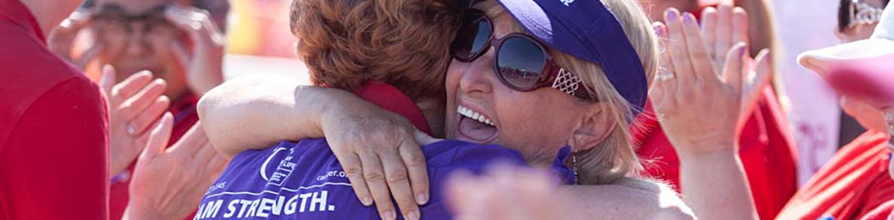 Cancer survivor hugging a fellow supporter